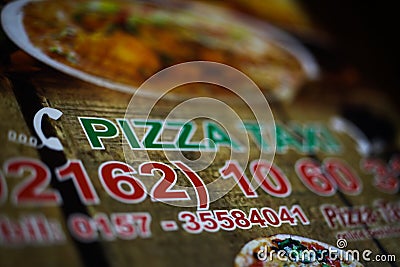 Closeup of menu card of 24 hours pizza delivery service Editorial Stock Photo