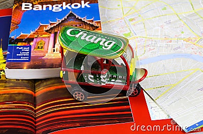 Travel guide, photo book, model of tuk tuk and city map for planning a trip to Bangkok Editorial Stock Photo