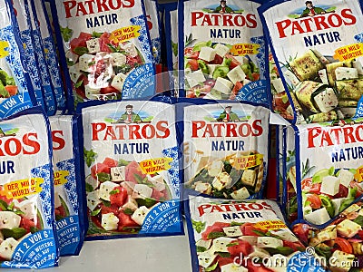 View on isolated Patros feta sheep cheese packs in cooling shelf of german supermarket Editorial Stock Photo