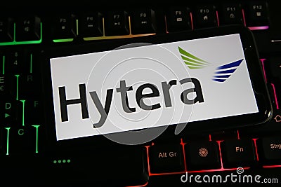 Closeup of mobile phone screen with logo lettering of Hytera communications on computer keyboard Editorial Stock Photo