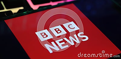 Closeup of smartphone with logo lettering of BBC breaking News on computer keyboard Editorial Stock Photo