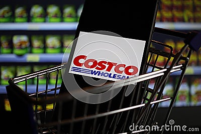 Close up of mobile phone screen in shopping cart modell with logo lettering of us american Costco wholesale supermarket chain Editorial Stock Photo