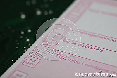 View on german medical prescription slip on computer circuit board Editorial Stock Photo