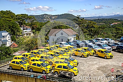 Open area for the sale of yellow cars in Da Lat Editorial Stock Photo