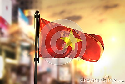 Vietnam Flag Against City Blurred Background At Sunrise Backlight Stock Photo