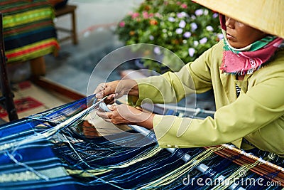 VIETNAM, HO CHI MINH - Vietnamese Woman Weaving Yarn On Street Editorial Stock Photo