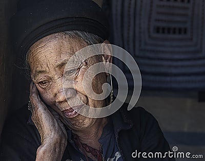 Hmong tribe old woman relaxing inside her house in her village in Sapa, Vietnam Editorial Stock Photo