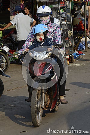 Vietnam Villages on motor bikes with young children Editorial Stock Photo