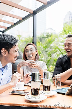 Vietnamese coffee served on the table of three friends outdoors Stock Photo