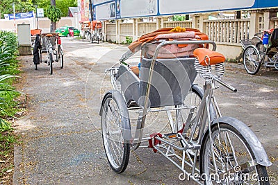 Ho Chi Minh City, Vietnam - September 1, 2018: Vietnamese cyclos and the shape of an undefined man in the back taking a break whil Editorial Stock Photo