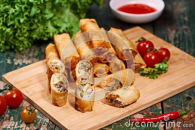 Vietnamese food. Delicious homemade spring rolls on wooden table Stock Photo