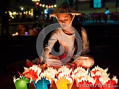 Vietnamese Girl Selling Candle Offerings in Hoi An, Vietnam Editorial Stock Photo