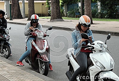 Vietnamese play pokemon go on motorbike Editorial Stock Photo