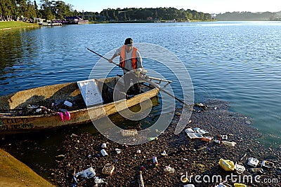 Vietnamese sanitation worker, rubbish, water, pollution Editorial Stock Photo