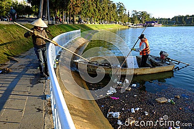 Vietnamese sanitation worker, rubbish, water, pollution Editorial Stock Photo