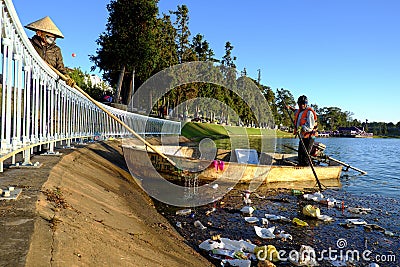 Vietnamese sanitation worker, rubbish, water, pollution Editorial Stock Photo