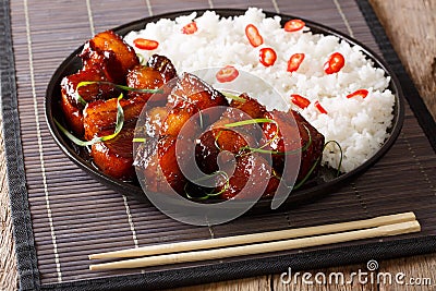 Vietnamese spicy caramel pork belly with rice closeup on a table Stock Photo