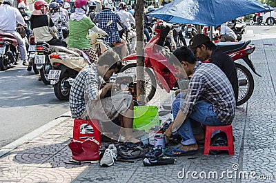 Vietnamese street shoe makers Editorial Stock Photo