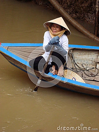 Vietnamese tourism boat woman in Mekong Delta Editorial Stock Photo