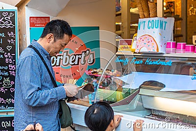 Vietnamese tourist paying for traditional czech food Editorial Stock Photo