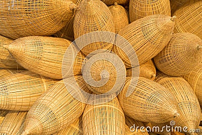 Vietnamese traditional bamboo fish trap background against cultivation field on background in flower arrange. Stock Photo