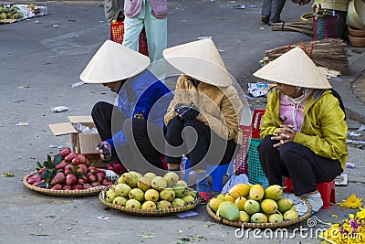 Vietnamese vendors selling fruit and vegetables at Dalat market Editorial Stock Photo
