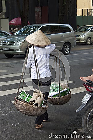 Vietnamese woman carries old paper and plastic Editorial Stock Photo