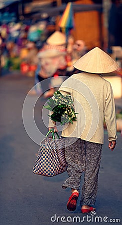 Vietnamese woman carrying bag Editorial Stock Photo