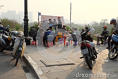 Vietnamese worker have breakfast at outside mobile restaurant Editorial Stock Photo