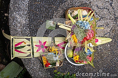 View from above of Balinese offerings on stone surface Stock Photo