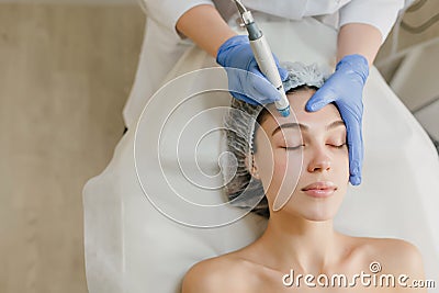 View from above of beautiful woman enjoying cosmetology procedures, rejuvenation in beauty salon. Dermatology, doctor at Stock Photo