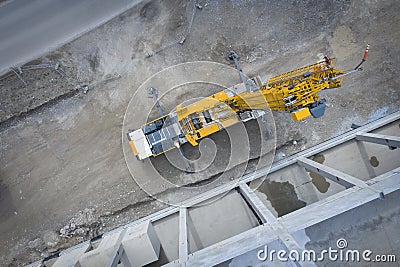 View from above on large heavy truck crane in front of concrete scaffolding Stock Photo