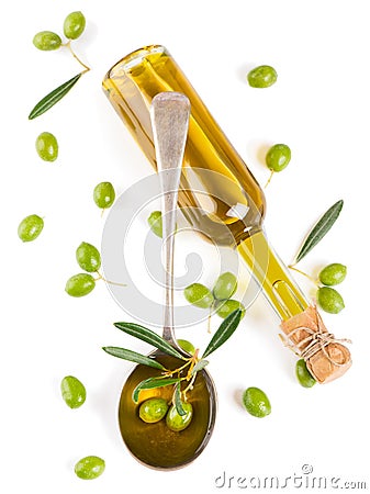 View from above of a olive oil in bottle, in a spoon and raw olives Stock Photo