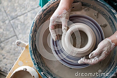 View from above of the potter`s wheel and the hands of the potter Stock Photo