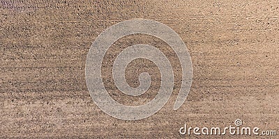 View from above on surface of gravel road with car tire tracks Stock Photo