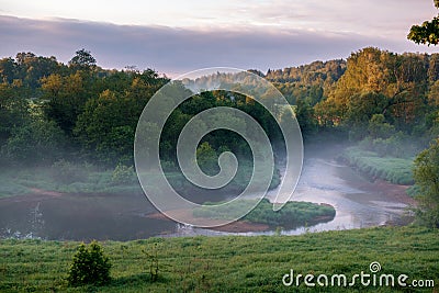 View from above to the small rural river at sunrise Stock Photo