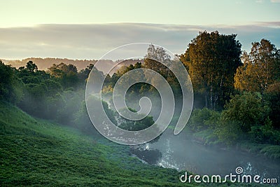 View from above to the small rural river at sunrise Stock Photo