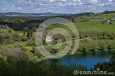 The view from above of the Weinfelder Maar and the Weinfelder Chapel Stock Photo
