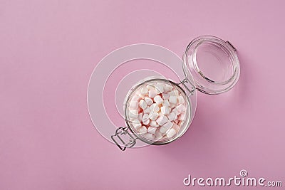 View from above of white and pink marshmallows in glass jar Stock Photo