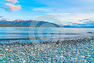 View across Lake Te ANau to Murchison Mountains just before sunrise Stock Photo