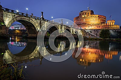 View across the river tiber of the St. Angelo Bridge to the fortress of Castel Sant'Angelo in Rome Italy Stock Photo