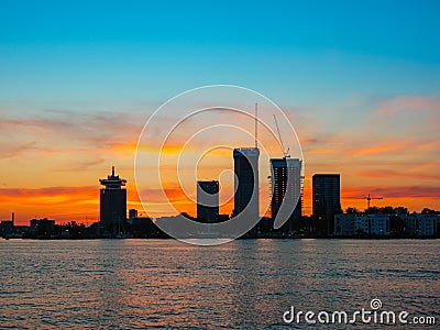 View of Adam tower and other nodern buildings during orange sunset, Amsterdam, Netherlands Stock Photo