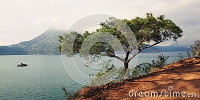 View on Adrasan Bay. Tourist boat in the sea. Aged photo. Stock Photo