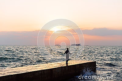 View from afar on sportsman with skipping rope, jumping on pier Stock Photo