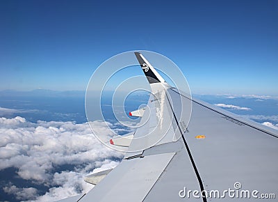 Wing of Air New Zealand jet aircraft in flight Editorial Stock Photo