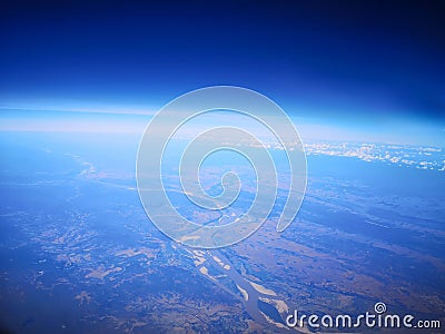 View from airplane at clouds, river under clouds Stock Photo