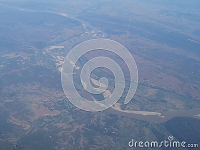 View from airplane at clouds, river under clouds Stock Photo