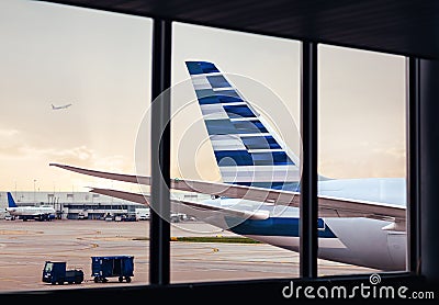 View of airplane fuselage tail with cargo through window at airport Stock Photo