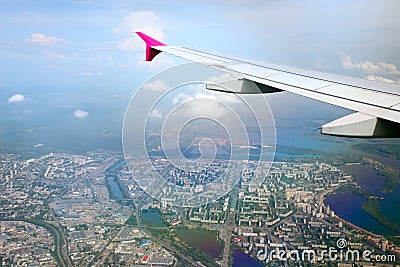 View from airplane of the wing and city beneath Stock Photo