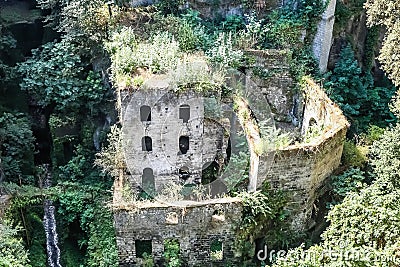 View of the ancient idyllic ruin of a mill in the valley Stock Photo